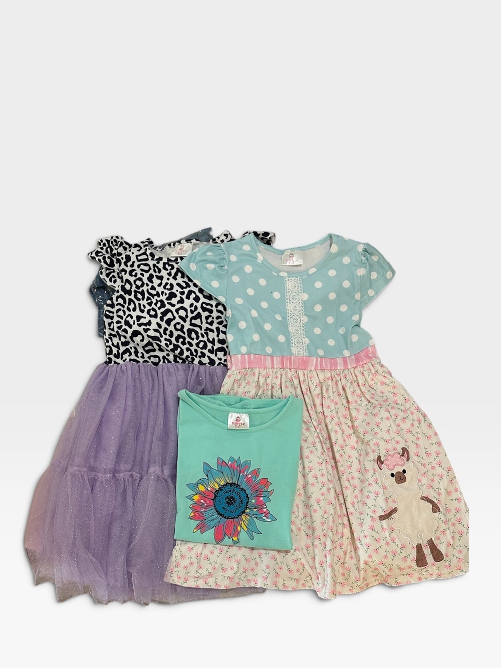 Bundle of 3 Ruffle Girl items. Featuring printed dress with purple bottom.